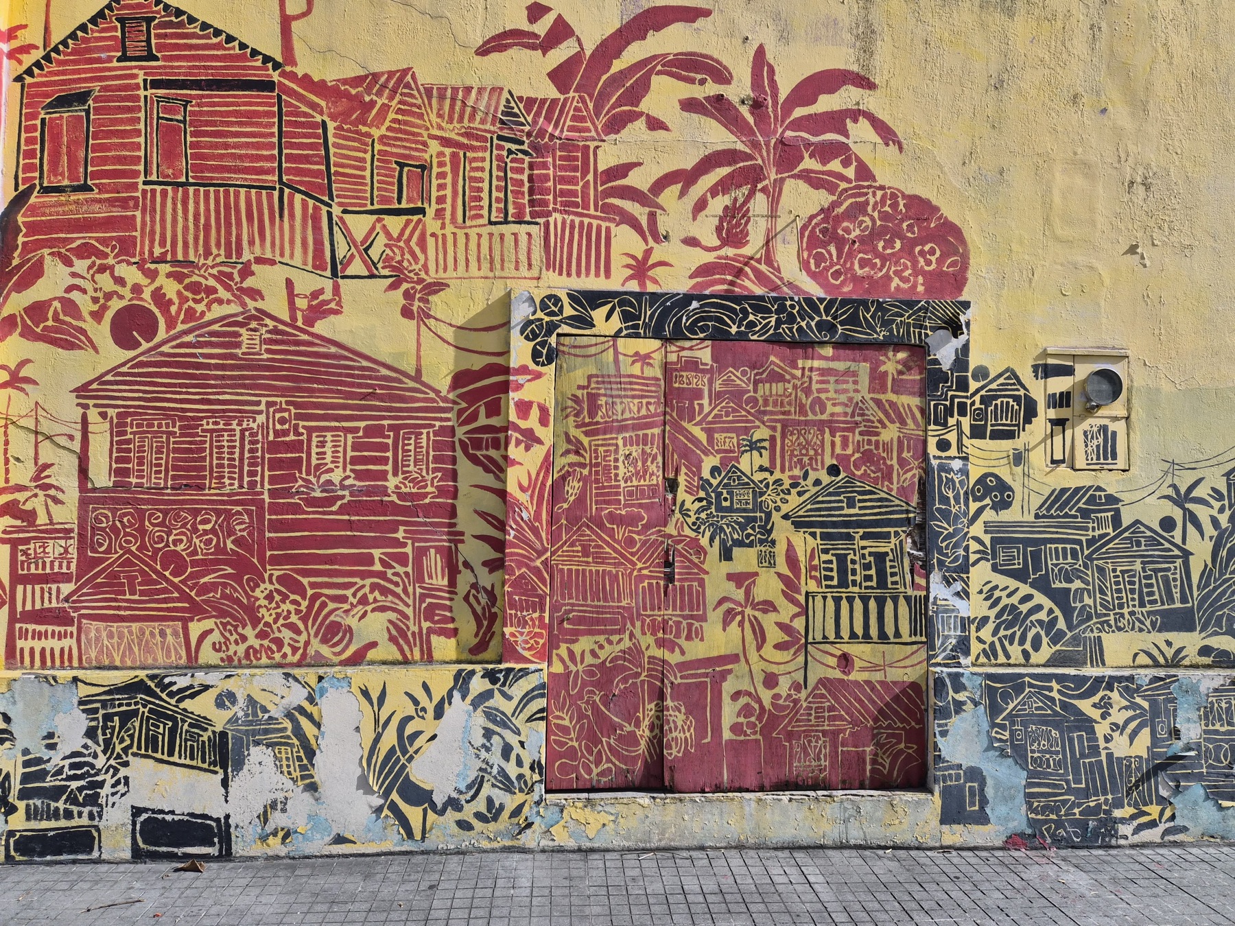 Mural of traditional wooden houses on a street in Ponce