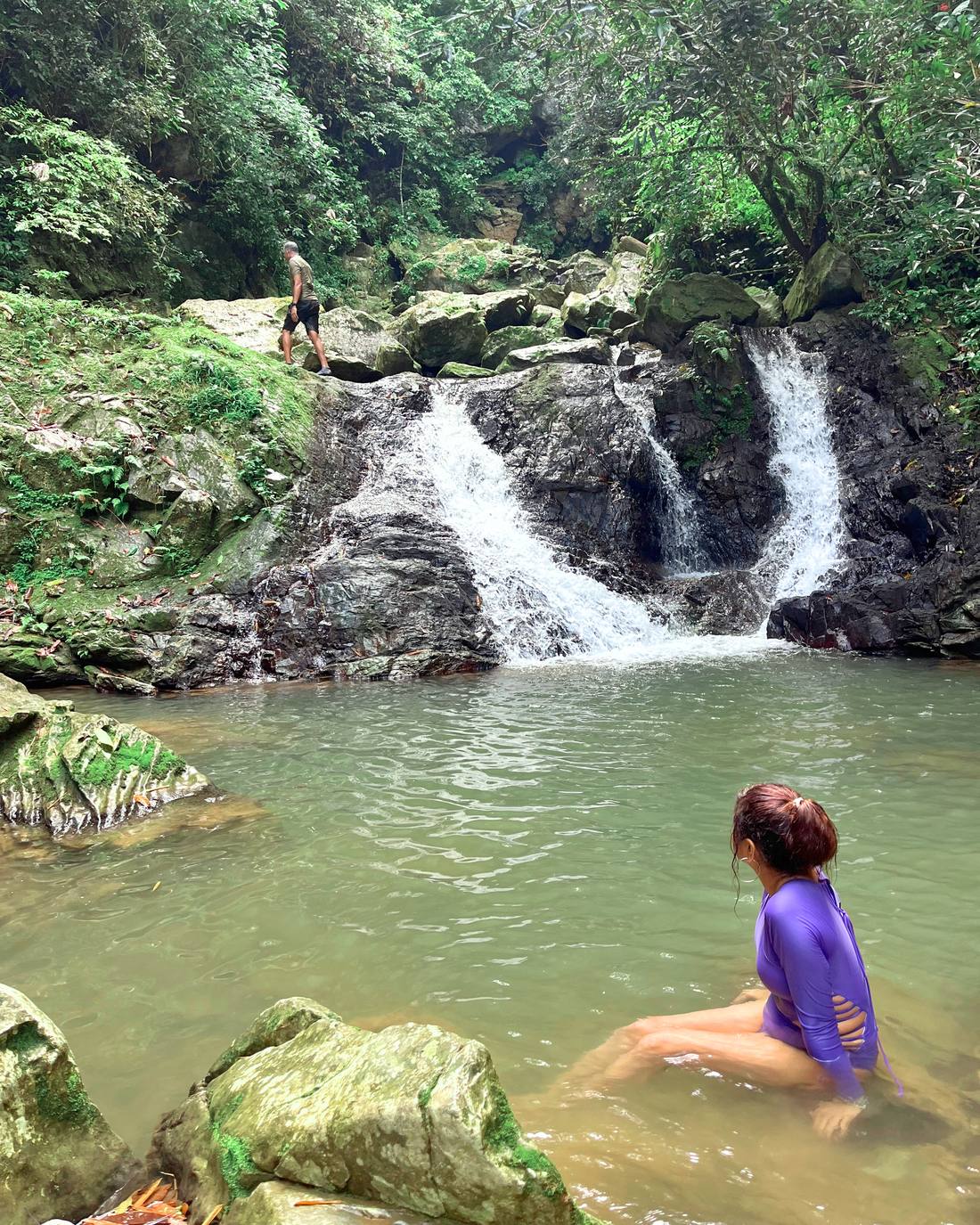 Natural river pool below a waterfall in the Puerto Rican countryside