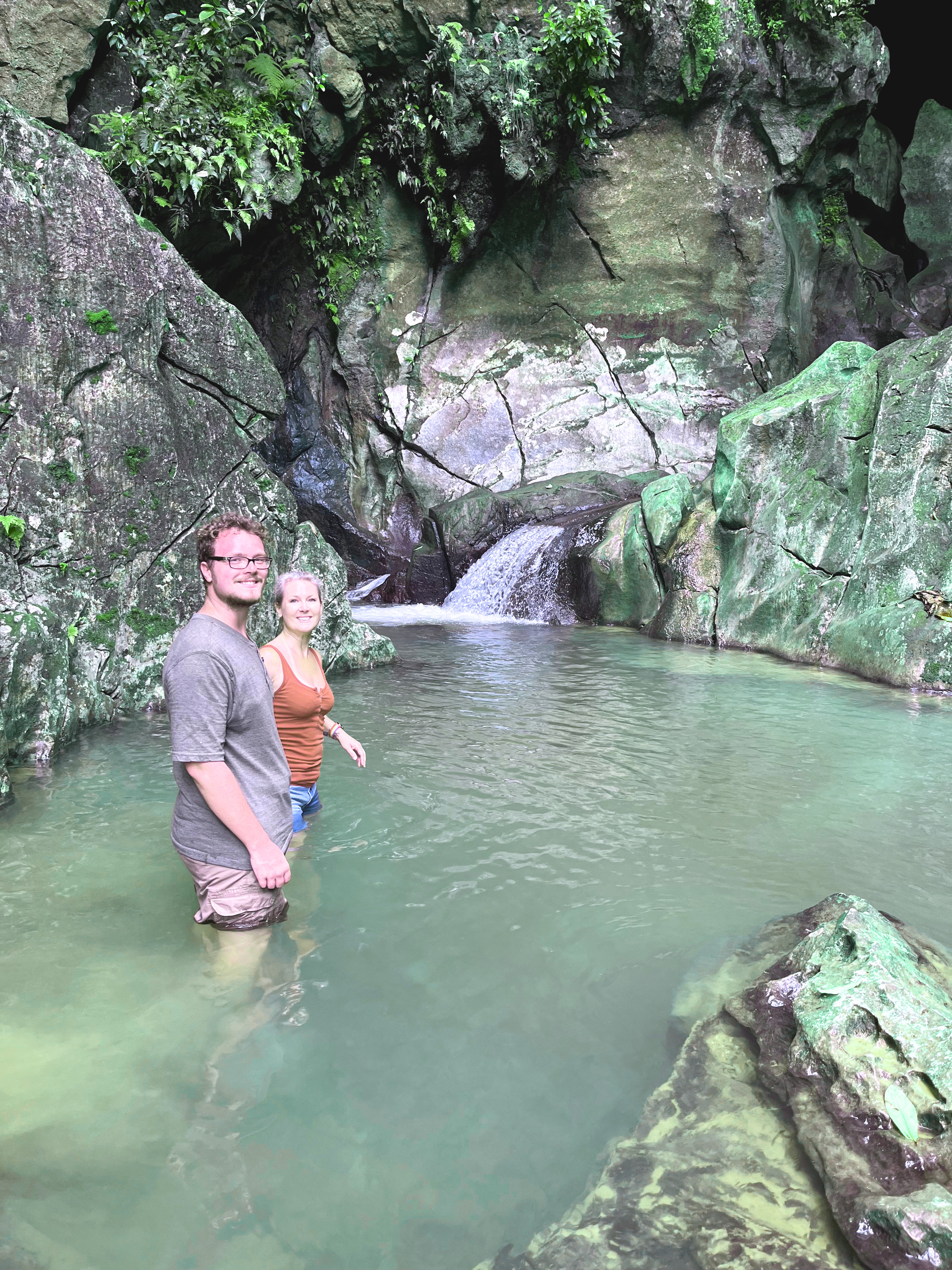 Forest waterfall hike during the wellness retreat